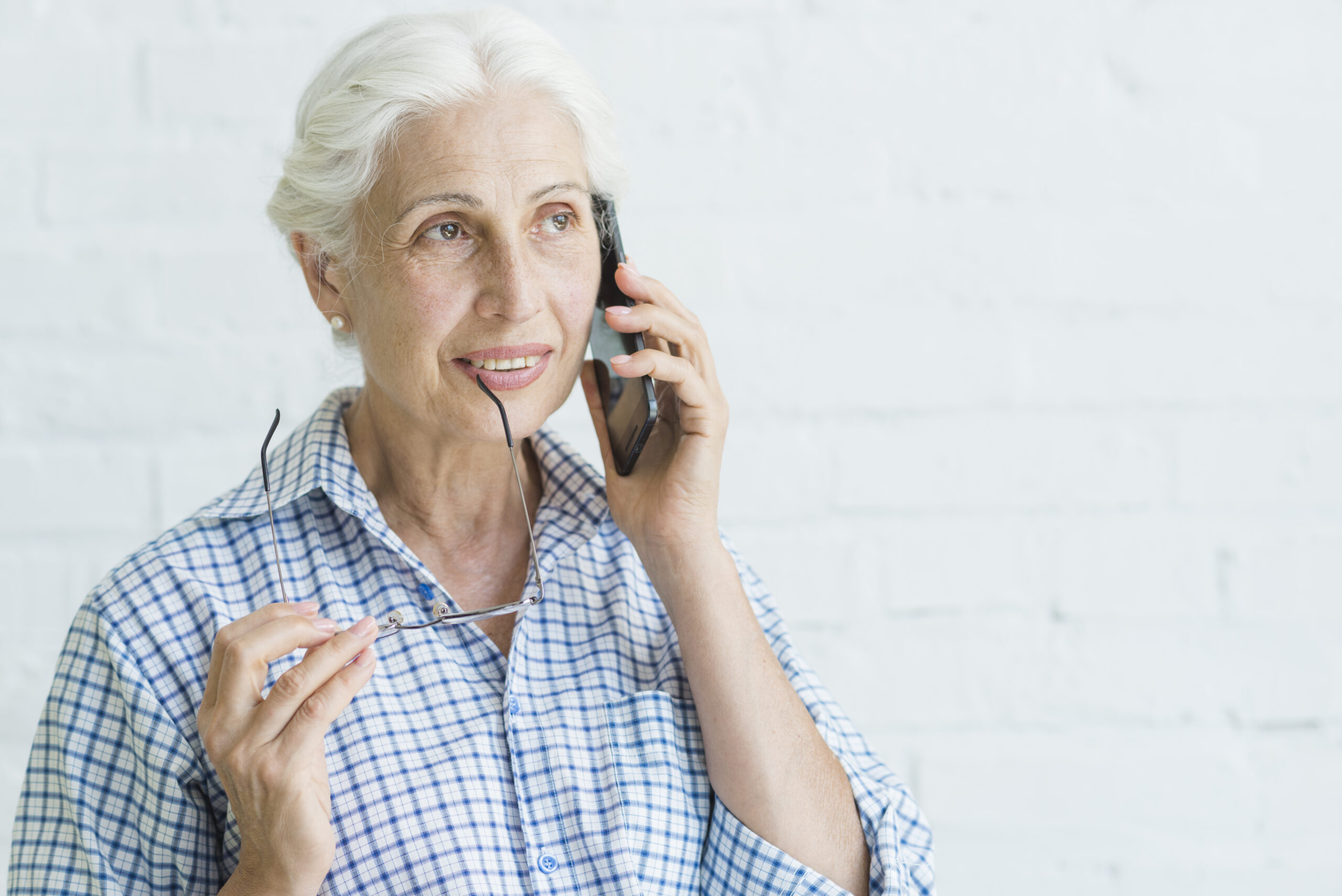 portrait-smiling-elderly-young-woman-talking-mobile-phone-scaled